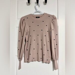 Adorable pink sweater. Features puff sleeves and subtle polka dots. Size small.